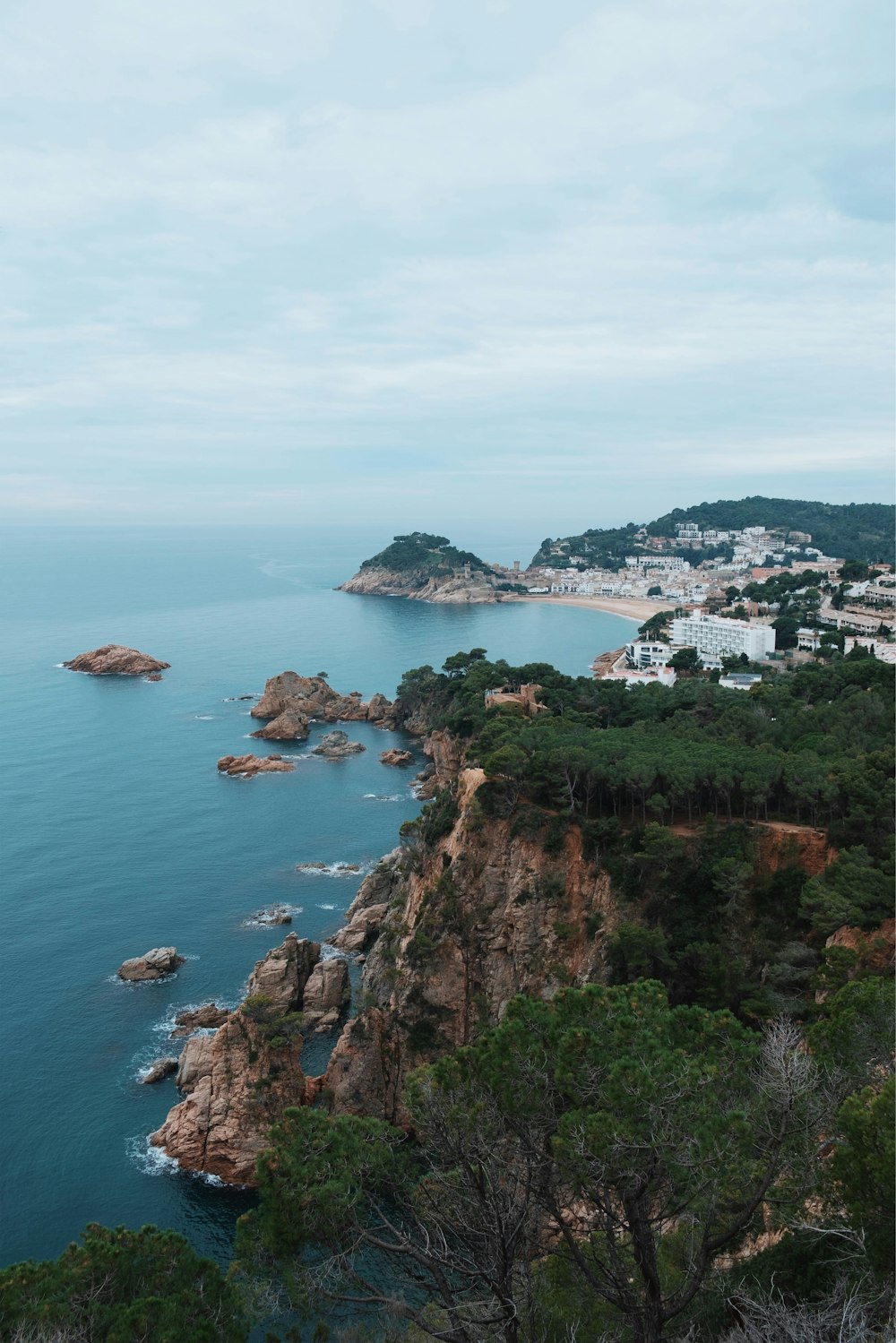 high-angle photography of rocky mountains beside beach