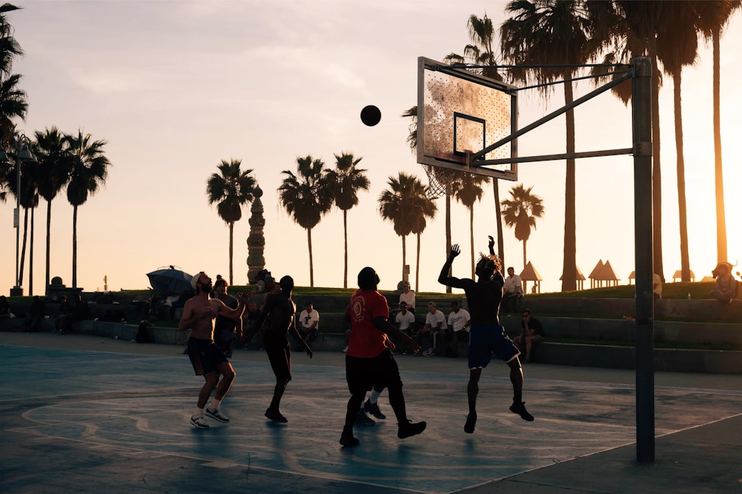 group of men playing basketball,