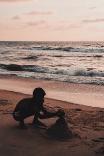 Simone and the kids building sandcastles on a sunny beach.