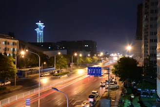 A city street at night lit warmly by vehicles equipped with Broled LED illumination
