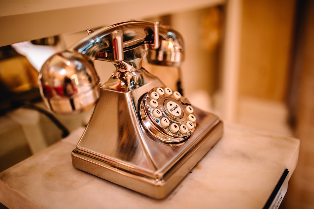 brown rotary phone on white panel