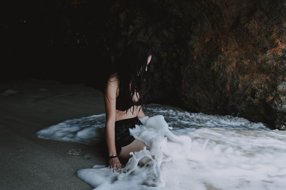 woman sitting on seashore