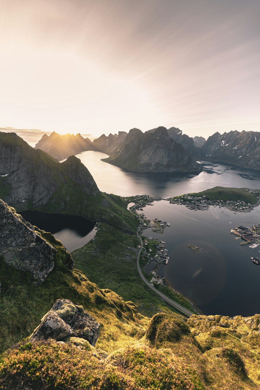 aerial photo of mountains surrounded with body of water during golden hour