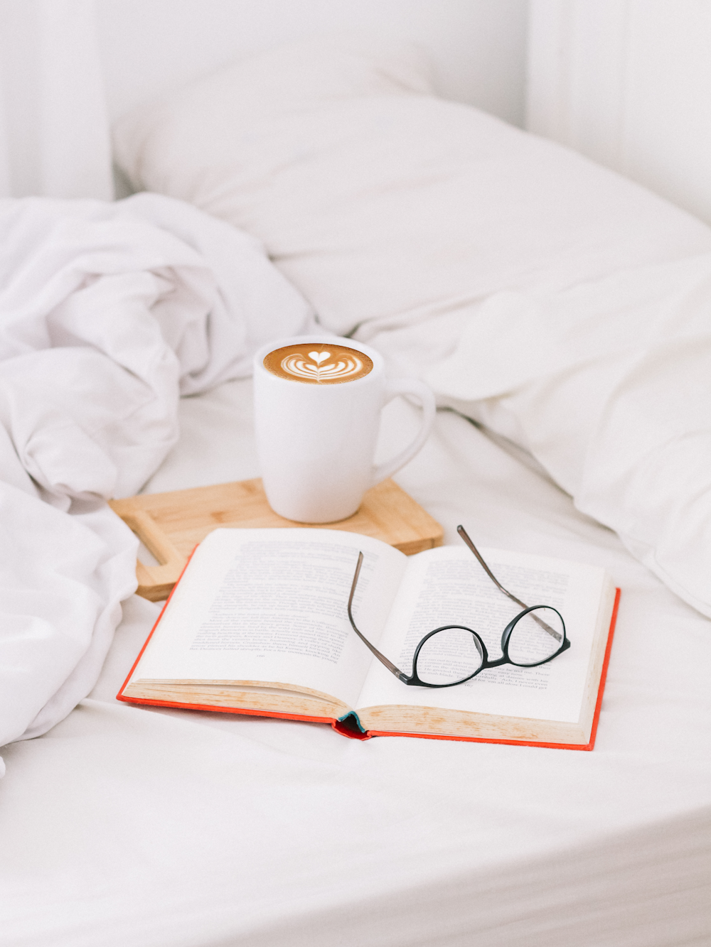 black framed eyeglasses on opened book