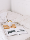 A cozy setup with a coffee cup, a book, and soft morning light.