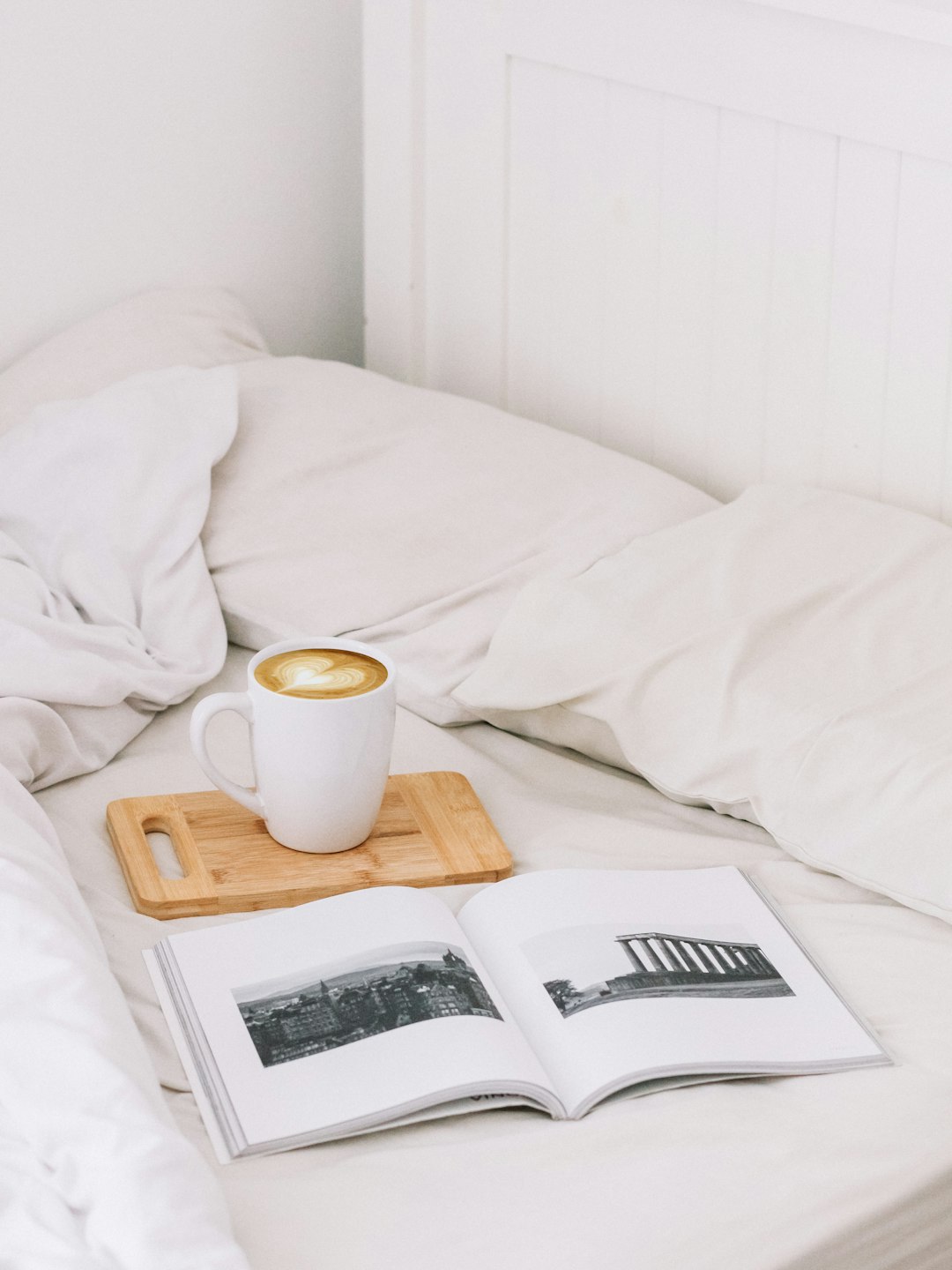 white mug on tray on bed