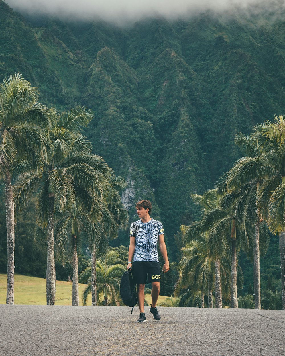 man walking on road