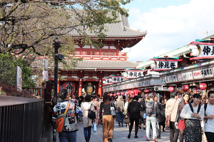 A friendly guide assisting a foreign visitor at a traditional Okinawan market.