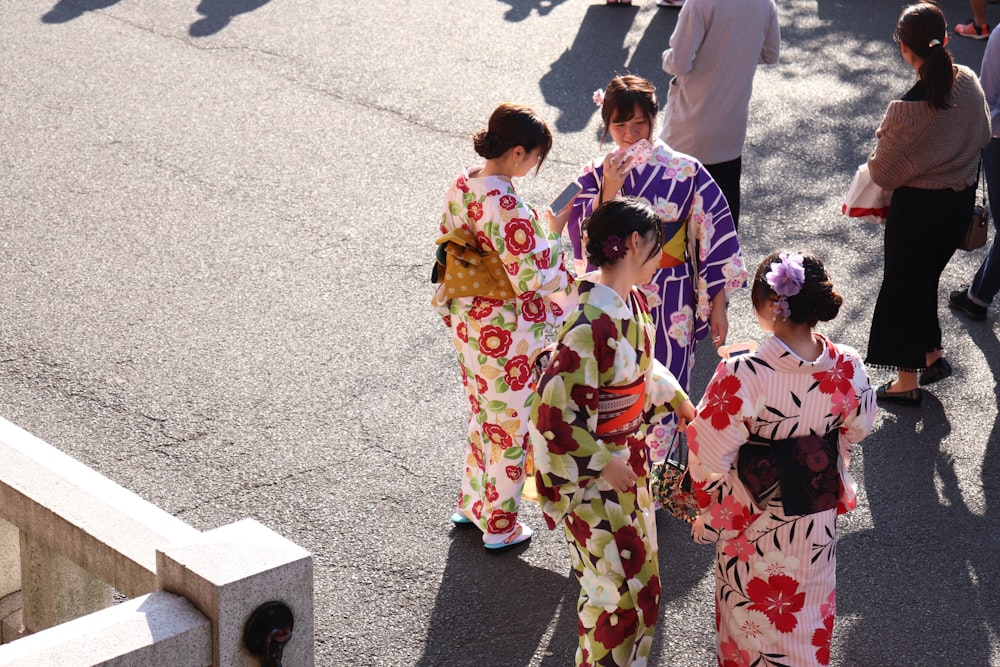 four women wearing cheongsam dress