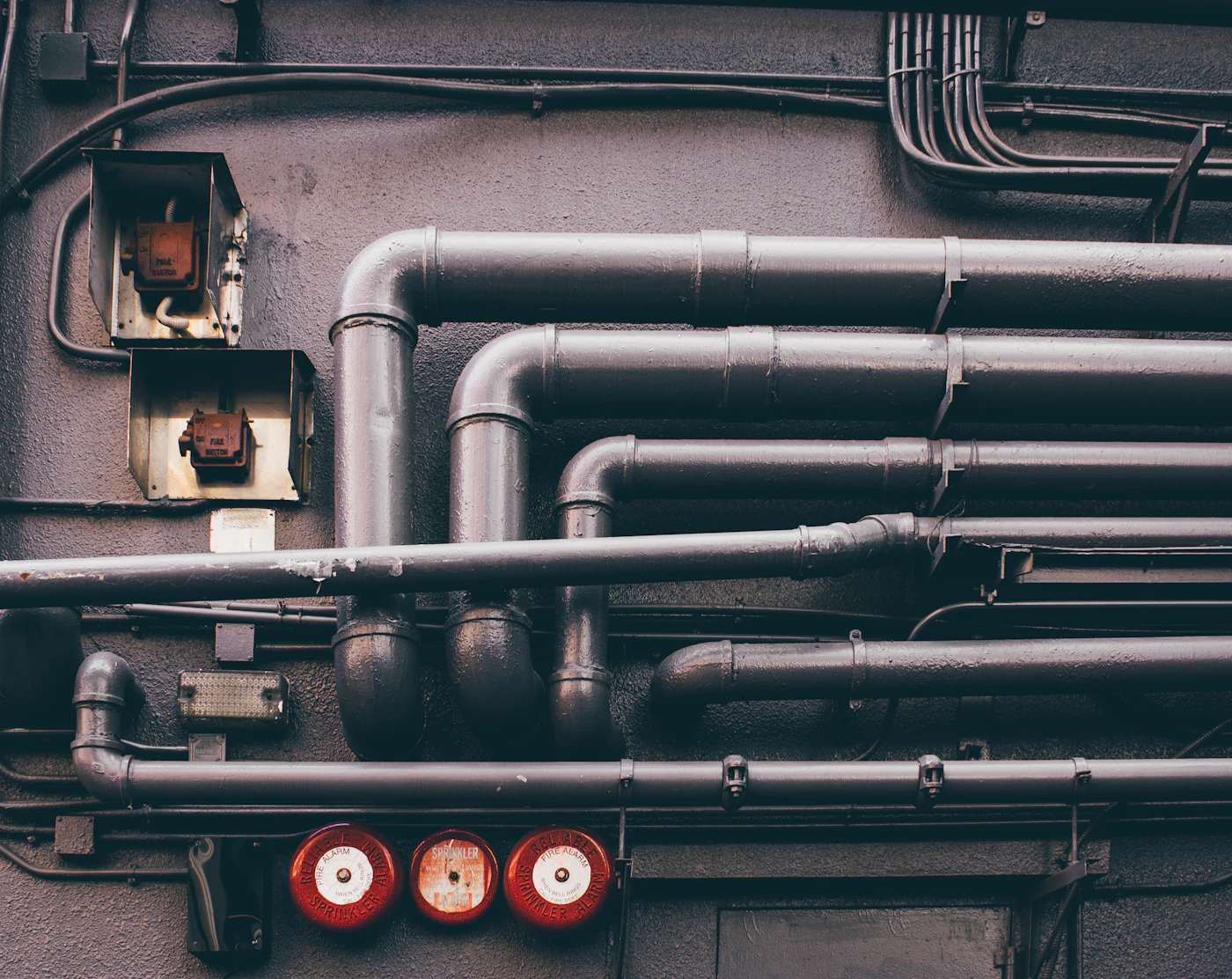 Plumber working on pipes during a leak repair