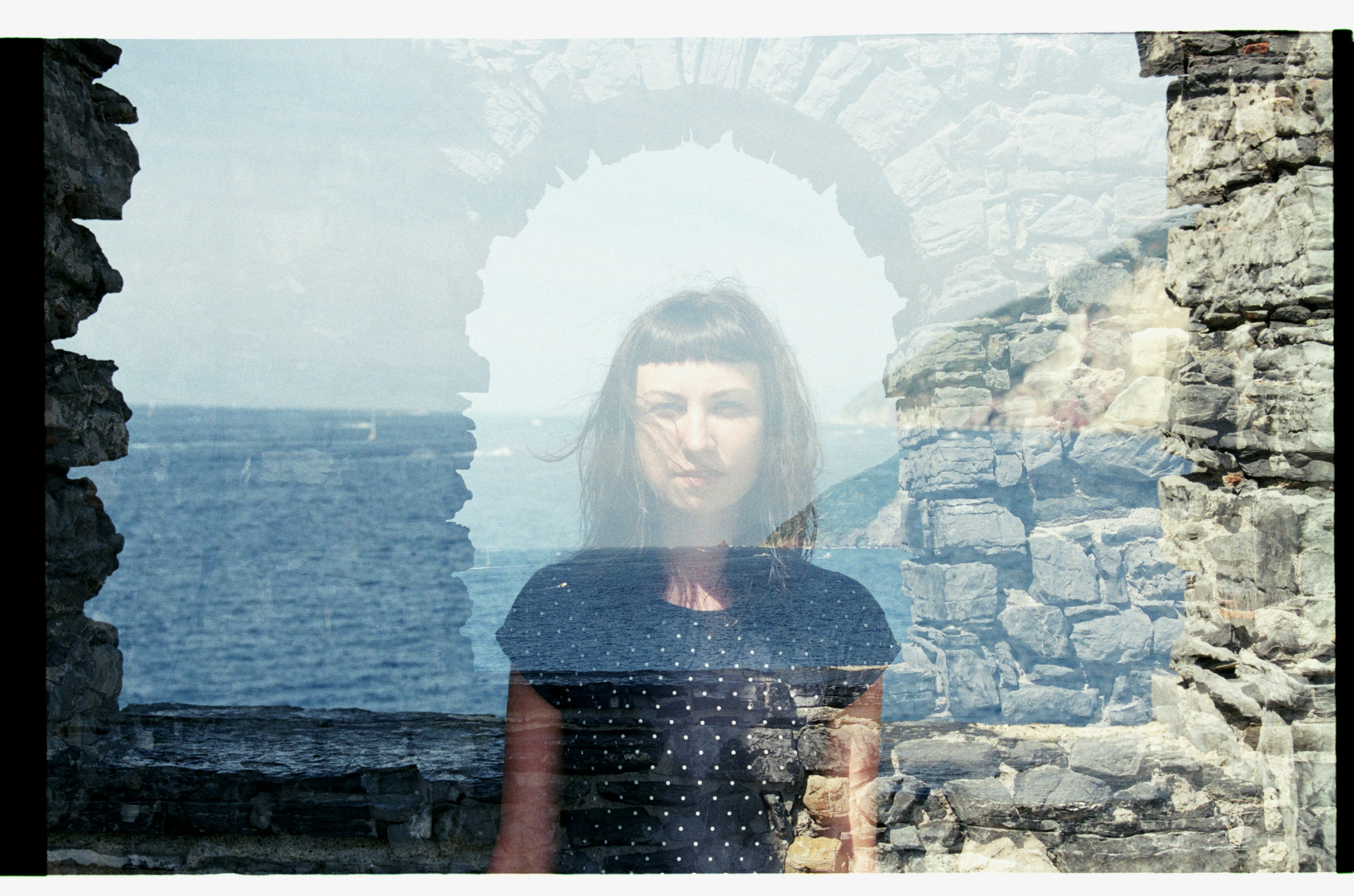 woman standing near body of water, 