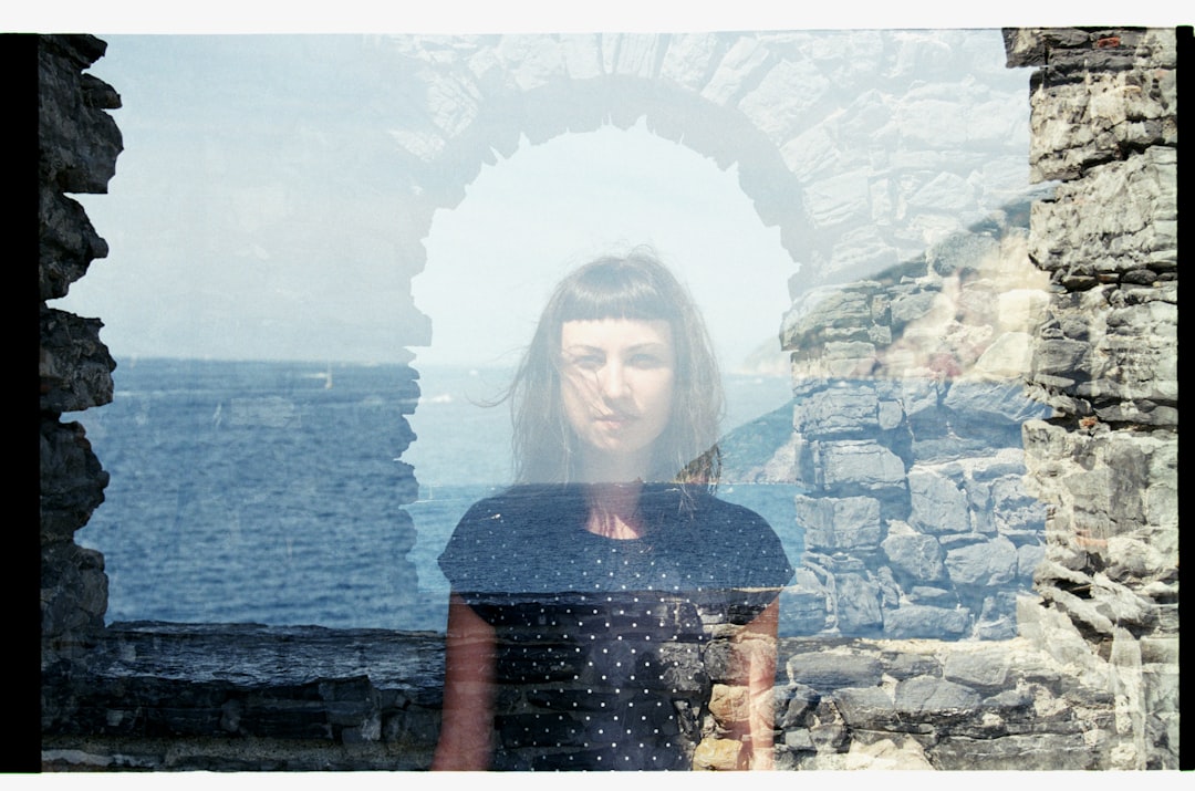 woman standing near body of water,