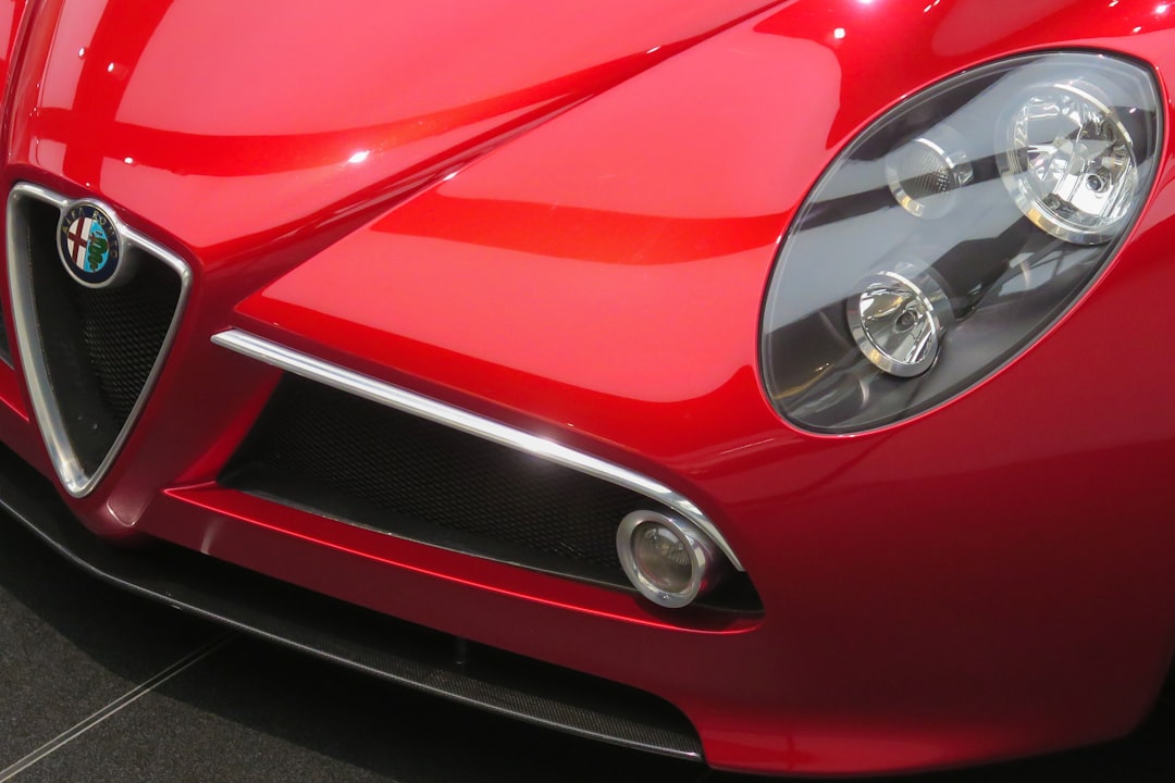 closeup photo of red Alfa Romeo vehicle