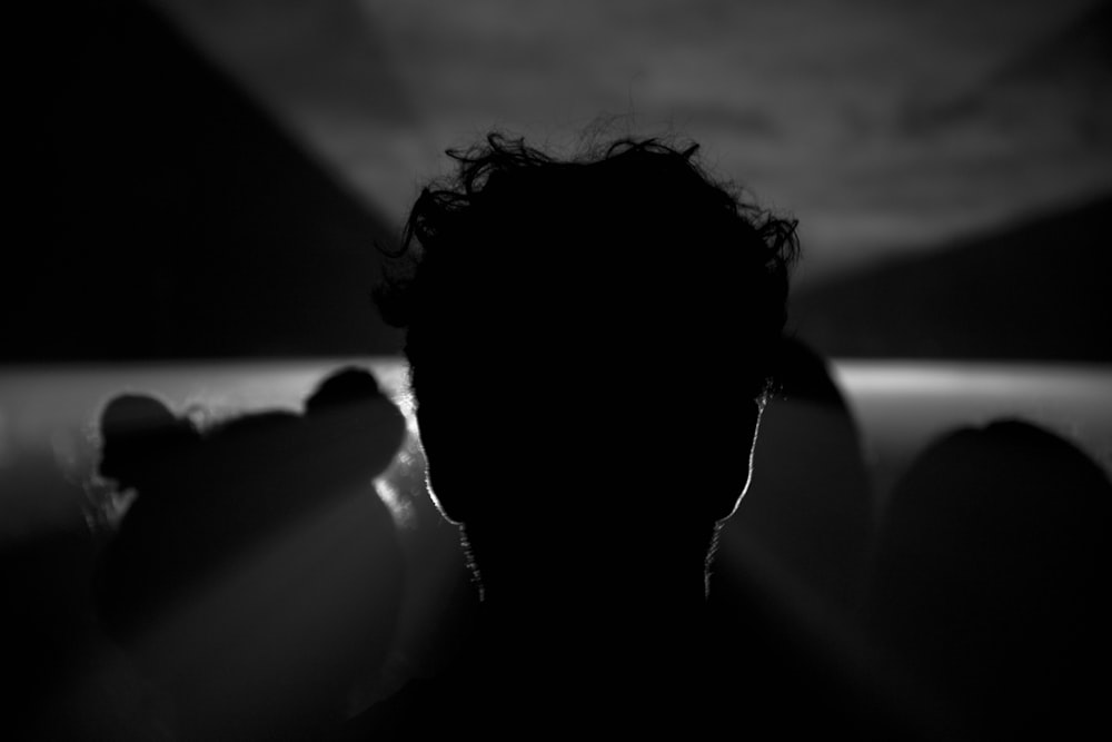 grayscale photography of silhouette of man