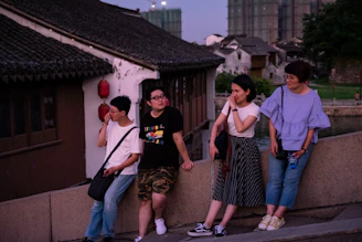 people leaning on fence