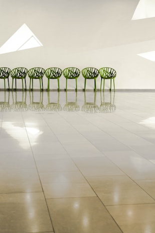 Freshly cleaned office chairs lined up in a bright workspace, highlighting restored fabric and freshness.