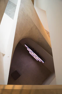 Visual interplay of industrial pieces and audiovisual elements merging in a minimalist space.