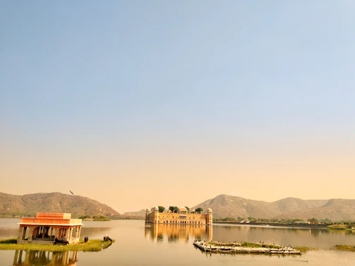 Sailing on Lake Pichola in Udaipur with palaces reflecting on the calm water.
