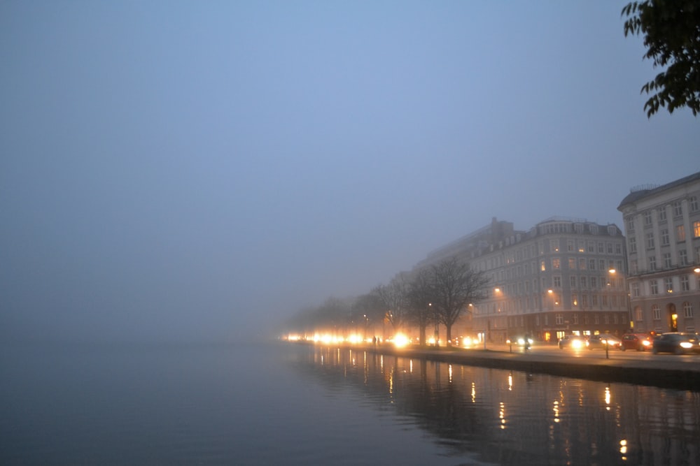 body of water near building during night time