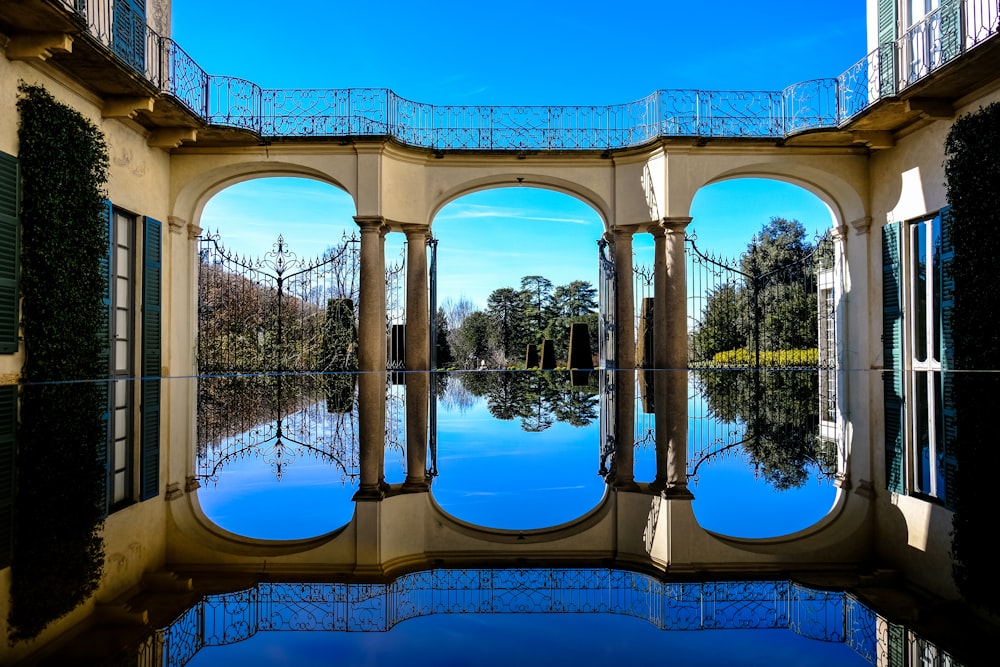 concrete bridge reflection on body of water