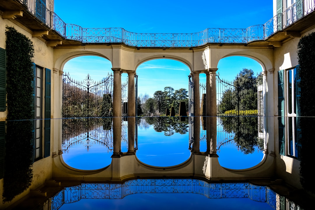 concrete bridge reflection on body of water