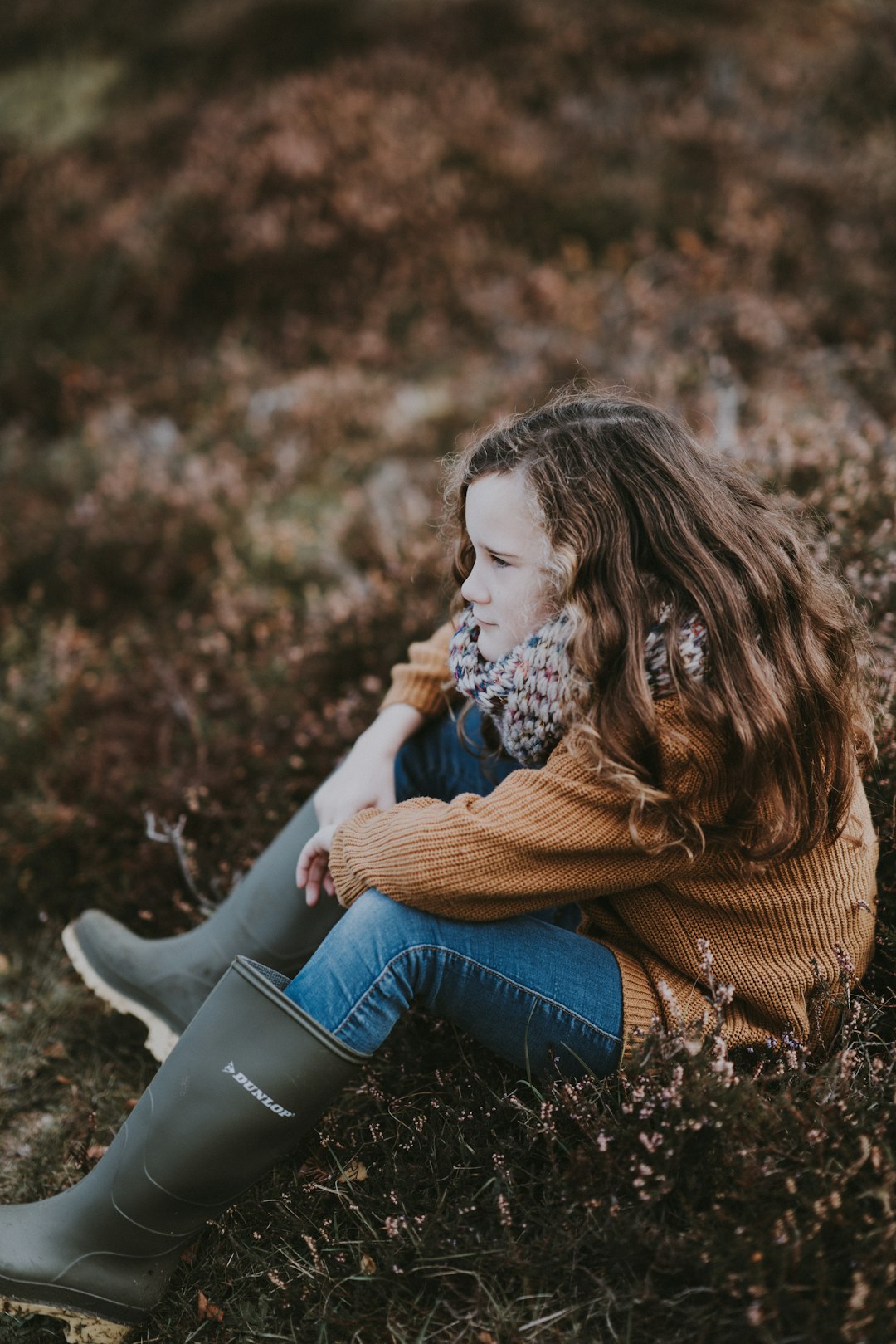 girl sitting on grass field