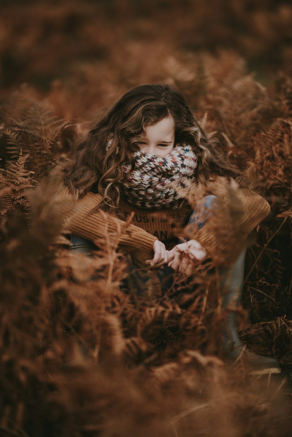 woman hiding on grass field