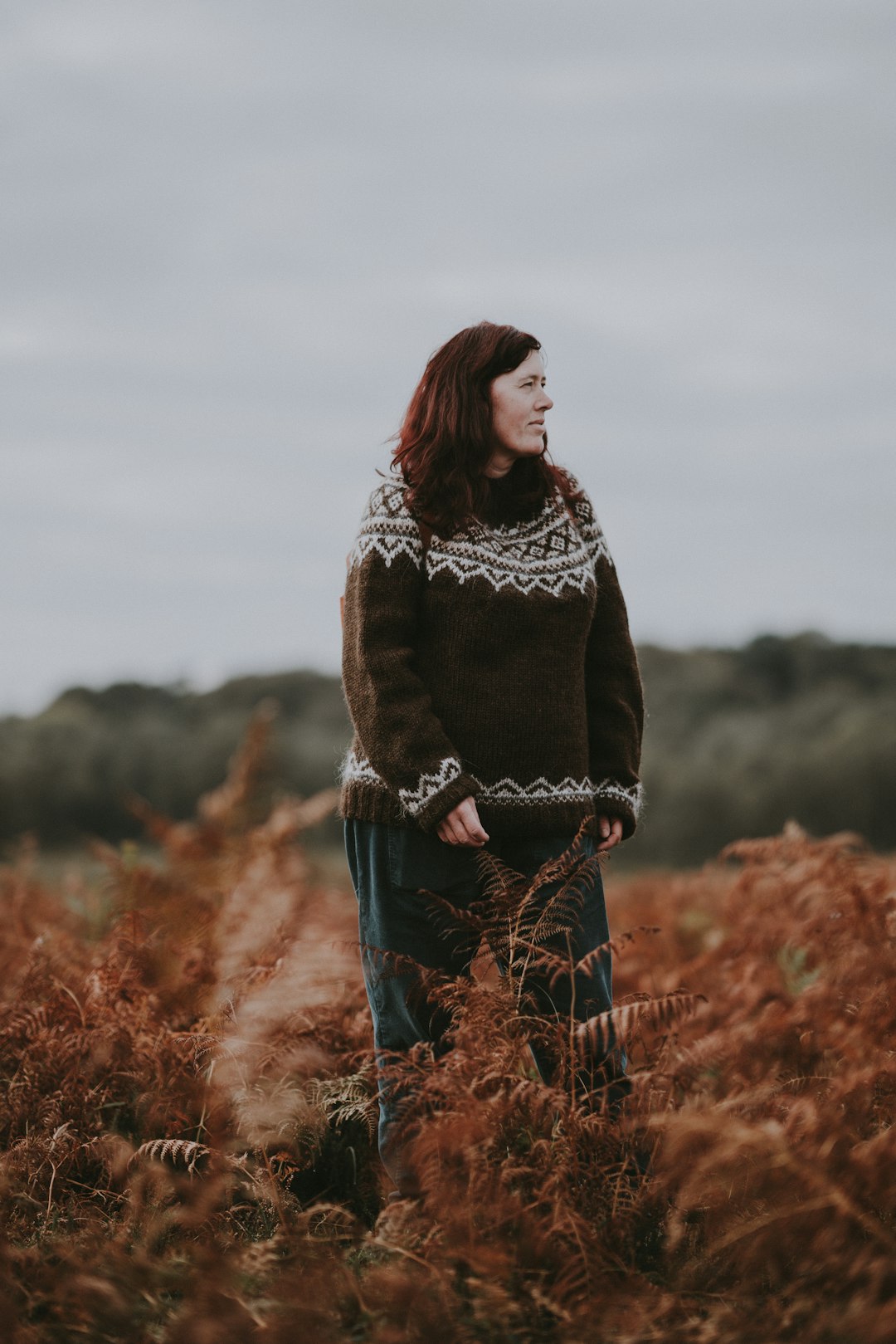 woman in brown white sweater standing