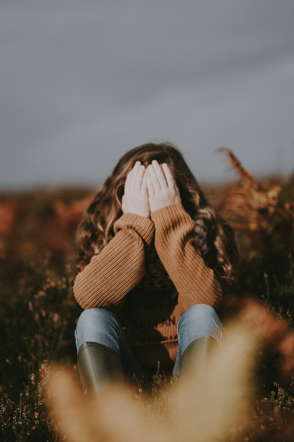 girl covering her face with her hands