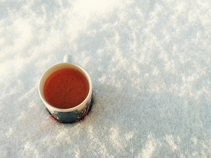 Close-up of a personalized magic mug changing color with a warm drink inside