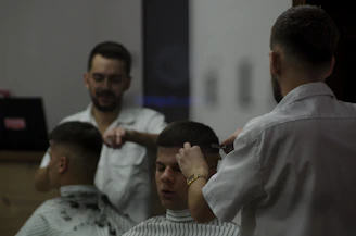 man cutting hair of another man