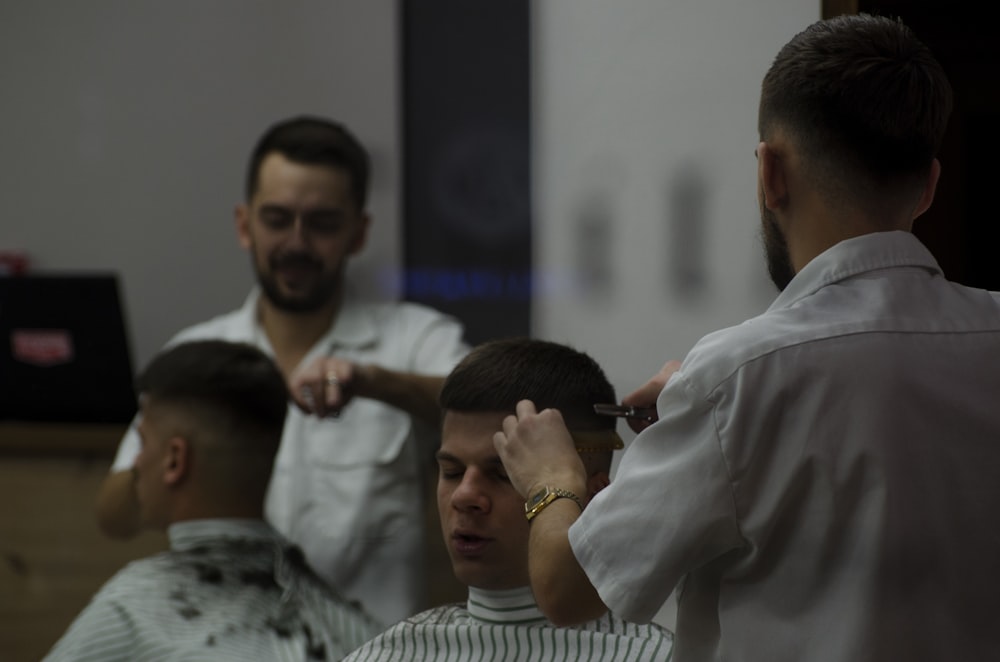 man cutting hair of another man
