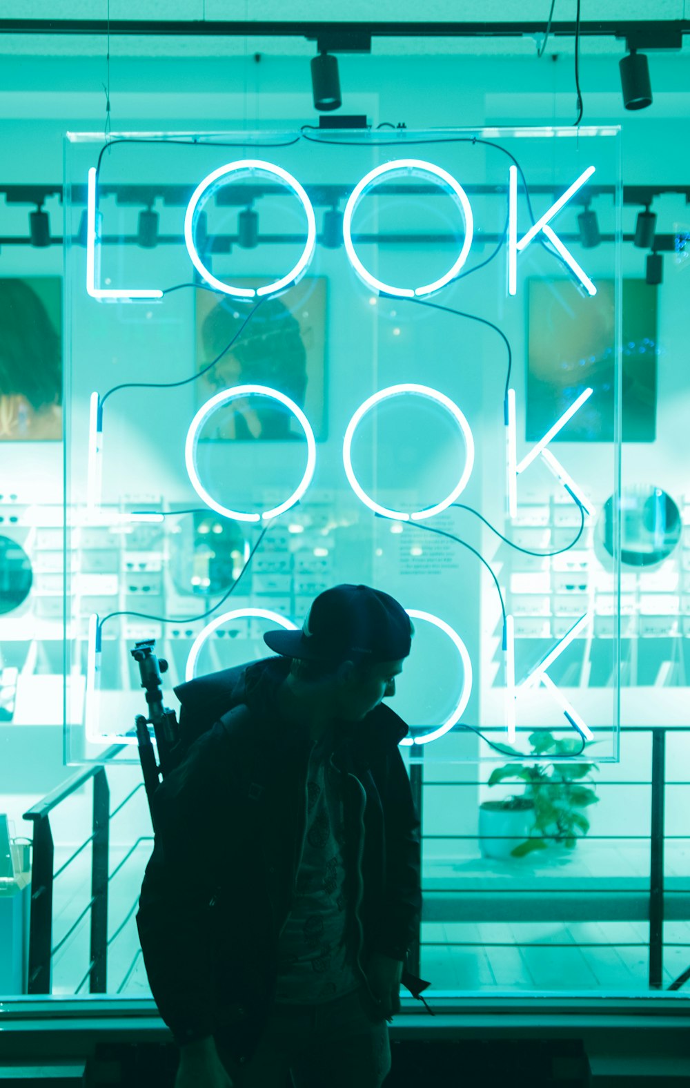 man standing near look LED signage