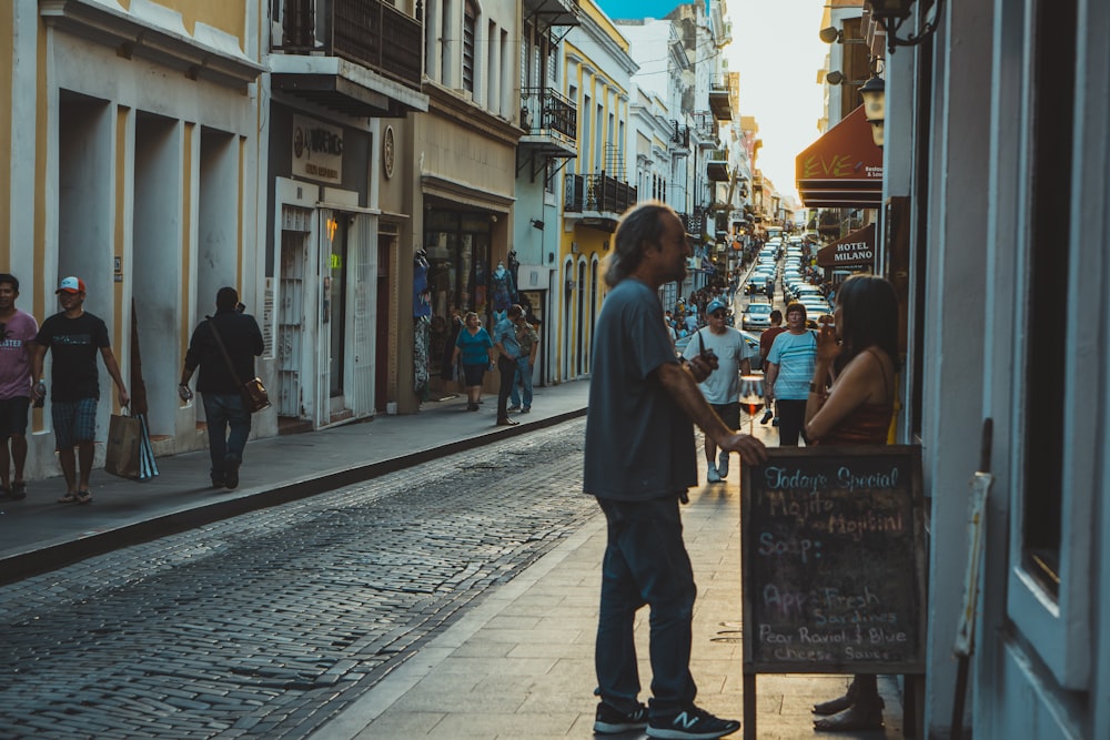 man leaning on signboard