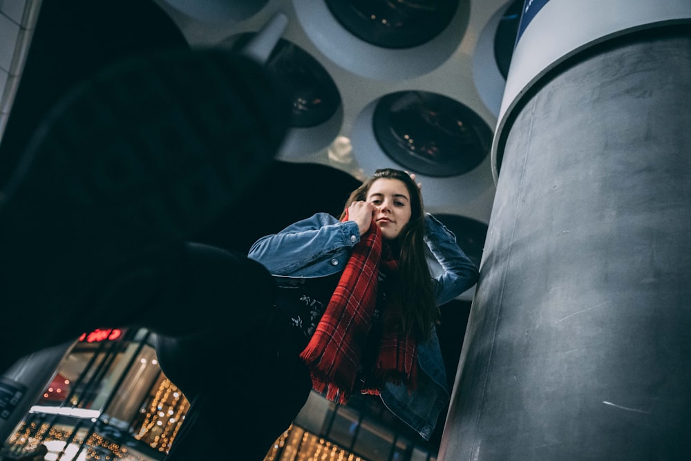 woman wearing blue jacket inside building