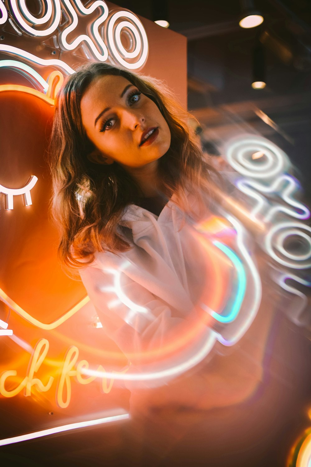 woman in white top in lighted decor