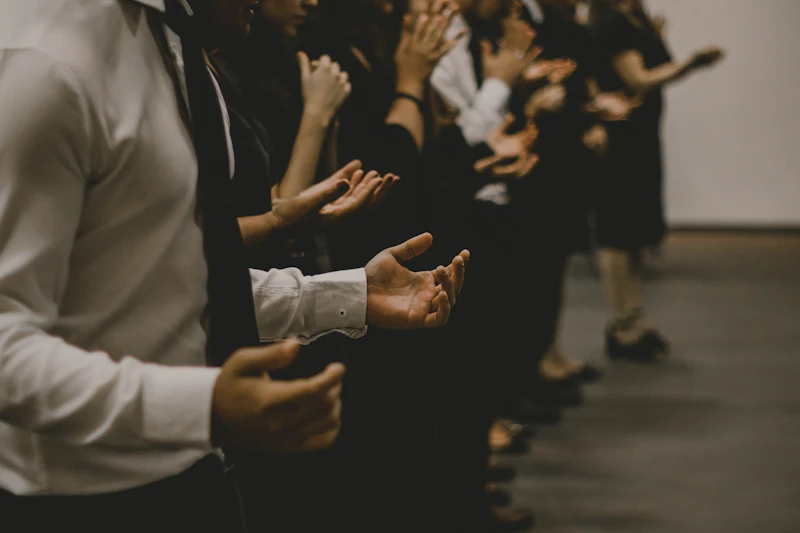 People worshipping with open hands during a service