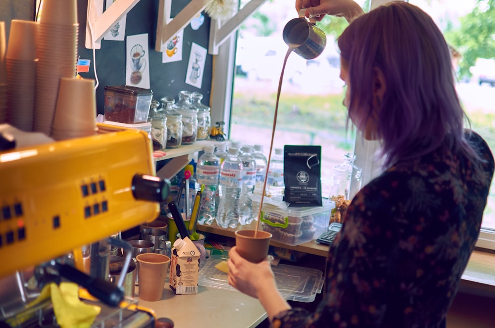 woman pouring coffee in cup