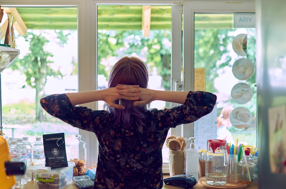 woman facing glass window