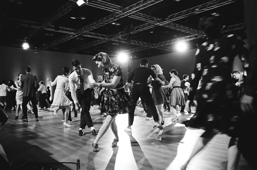 grayscale photography of people dancing on stage