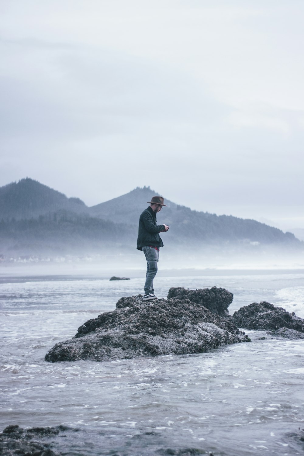 man standing beside body of water during daytime