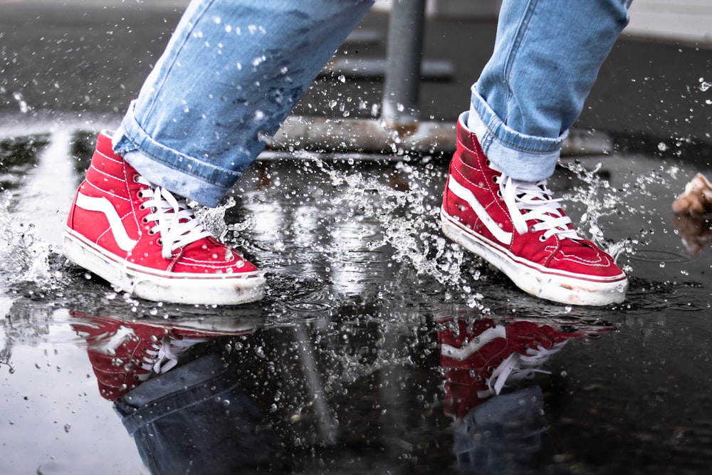 person in blue denim jeans walking on water