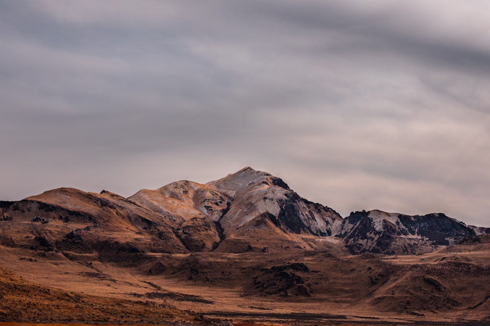 rocky mountain under gray sky