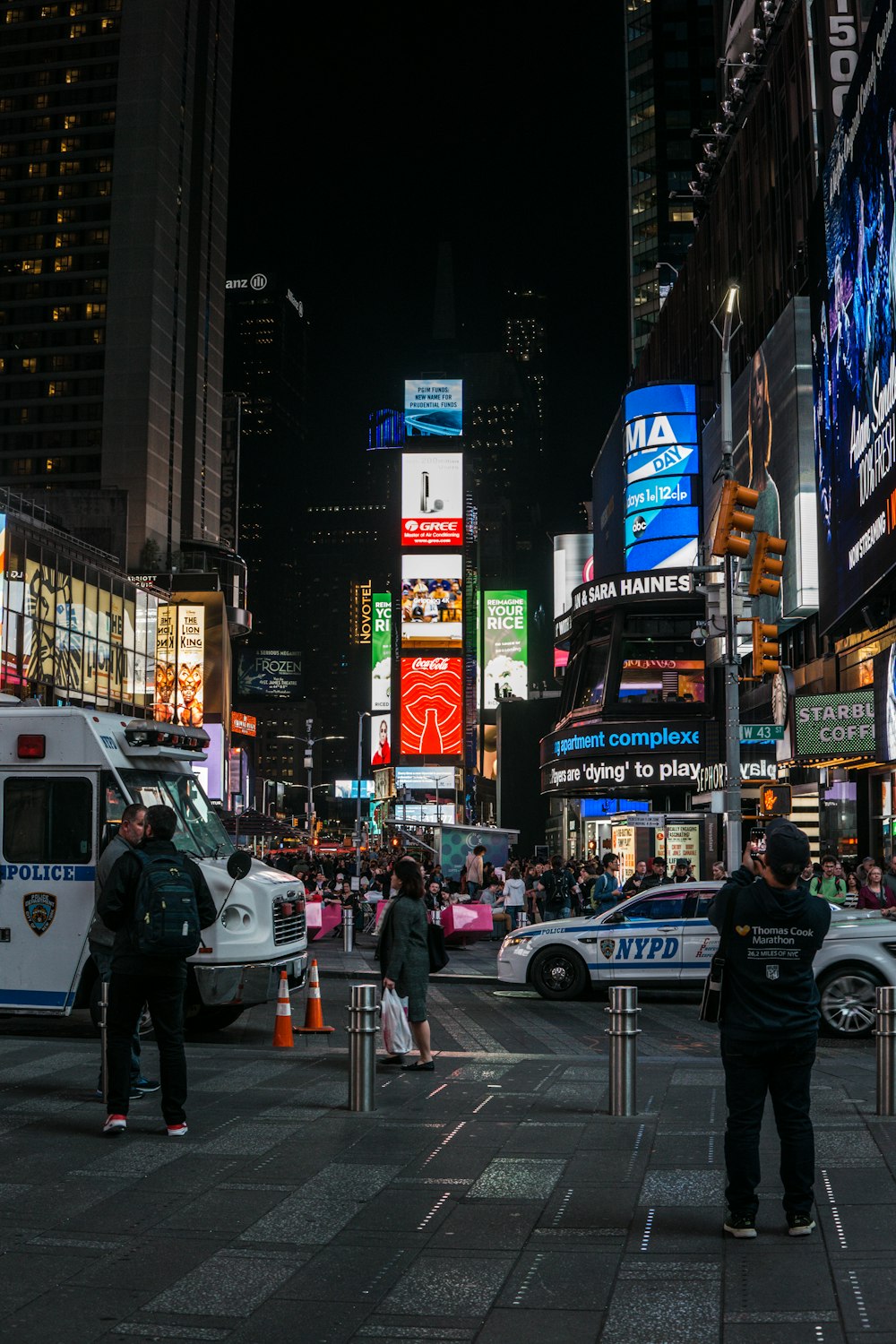 people walking in the street during nightime