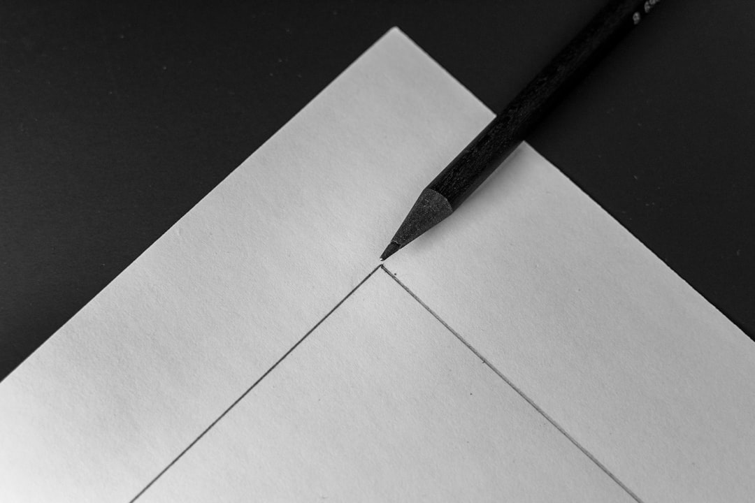 black pencil on white paper close-up photography