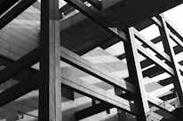 An abstract composition of intersecting steel beams forming a strong, geometric pattern.