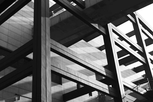 Abstract architectural detail showing intersecting steel beams with sharp lines and shadows
