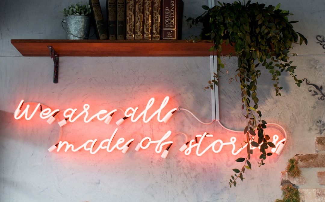 We are all made of stories, in reddish neon sign