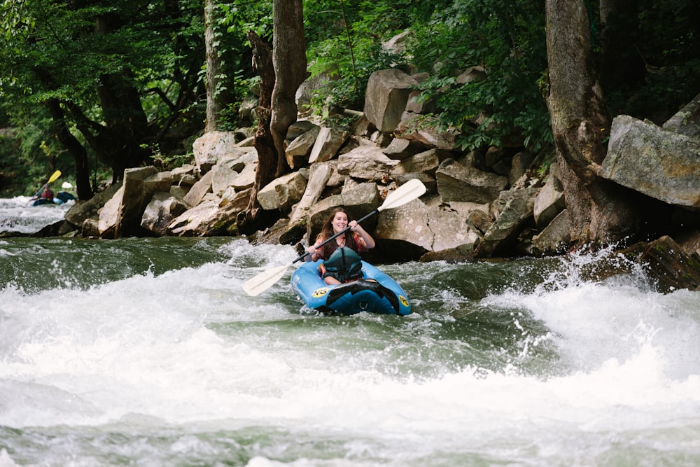 woman kayaking on rapids