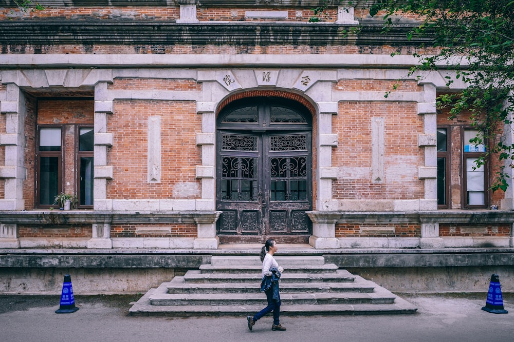 woman standing in front of mansion